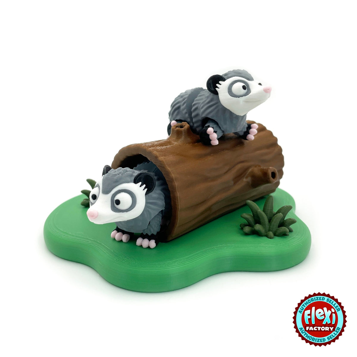 Cute opossum keychain, 3D printed by RU3D – on top of hollow log playset. Grey and white with pink tail and hollow log playset.