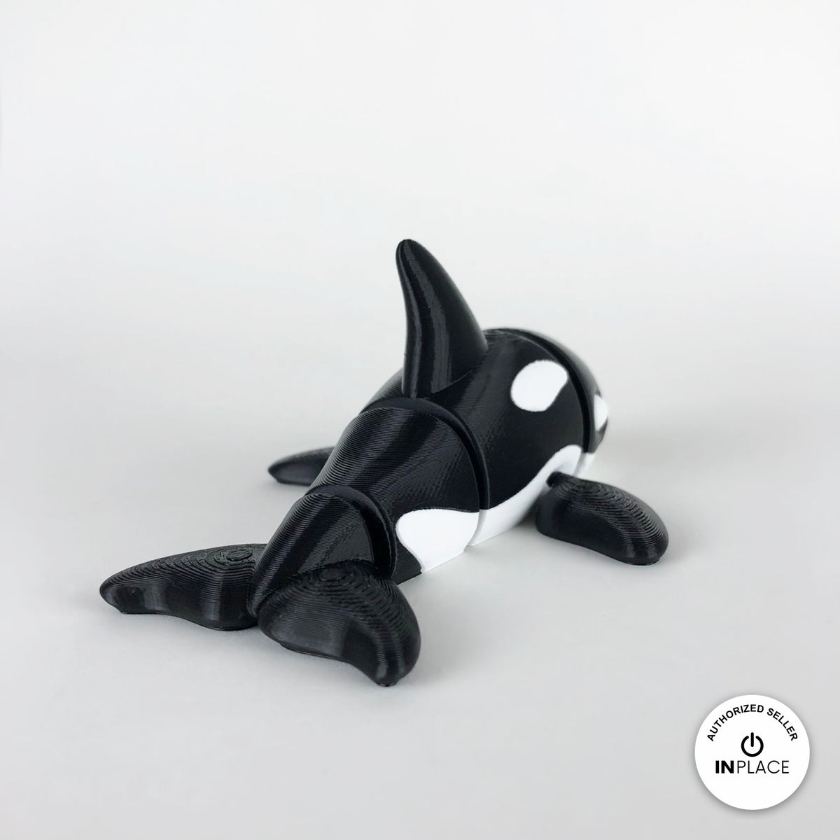 Cute orca killer whale keychain, 3D printed by RU3D – rear three quarter view. Black and white.