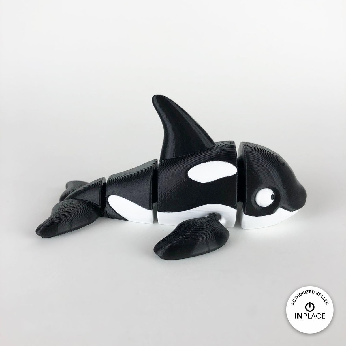 Cute orca killer whale keychain, 3D printed by RU3D – side view facing right. Black and white.