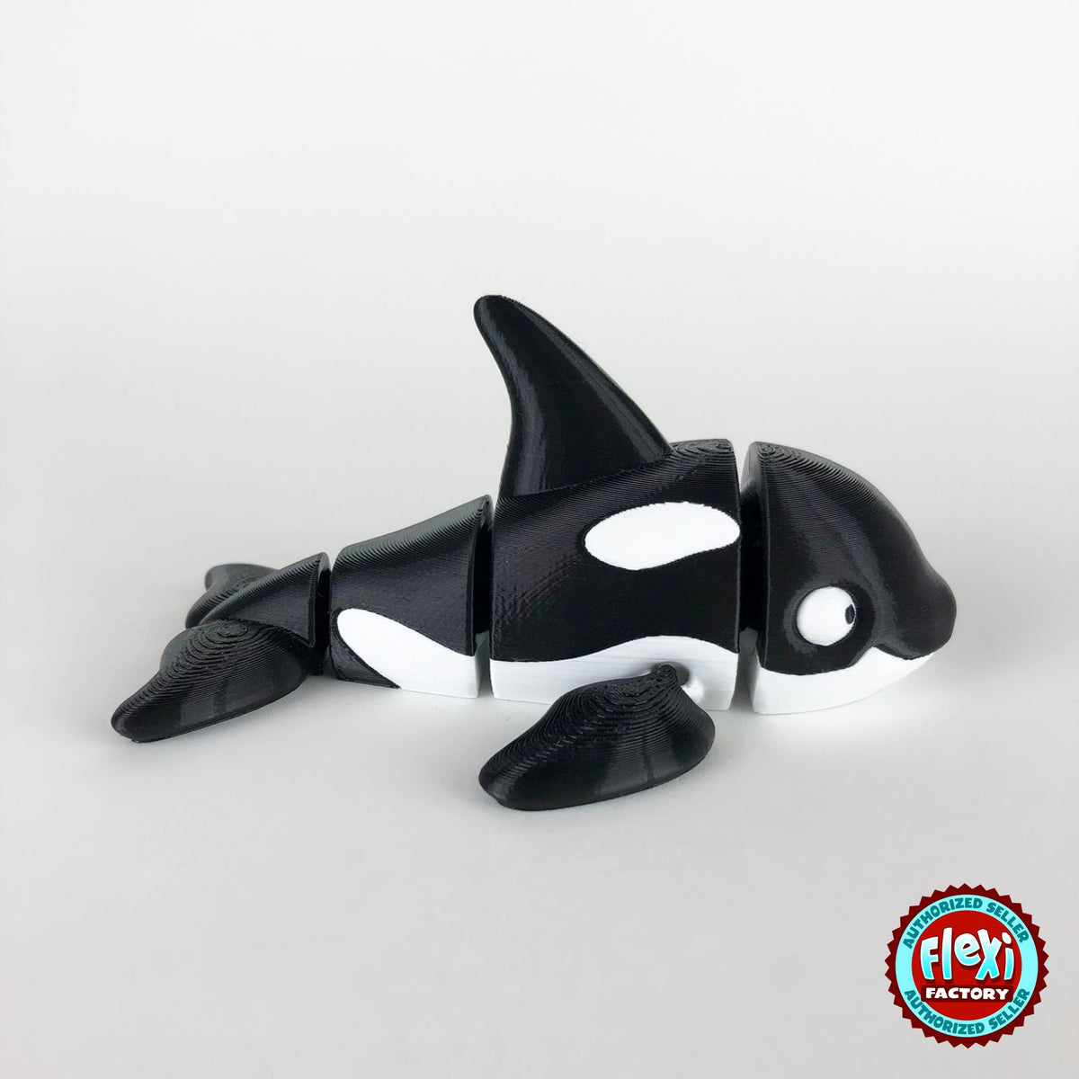 Cute orca killer whale keychain, 3D printed by RU3D – side view facing right. Black and white.
