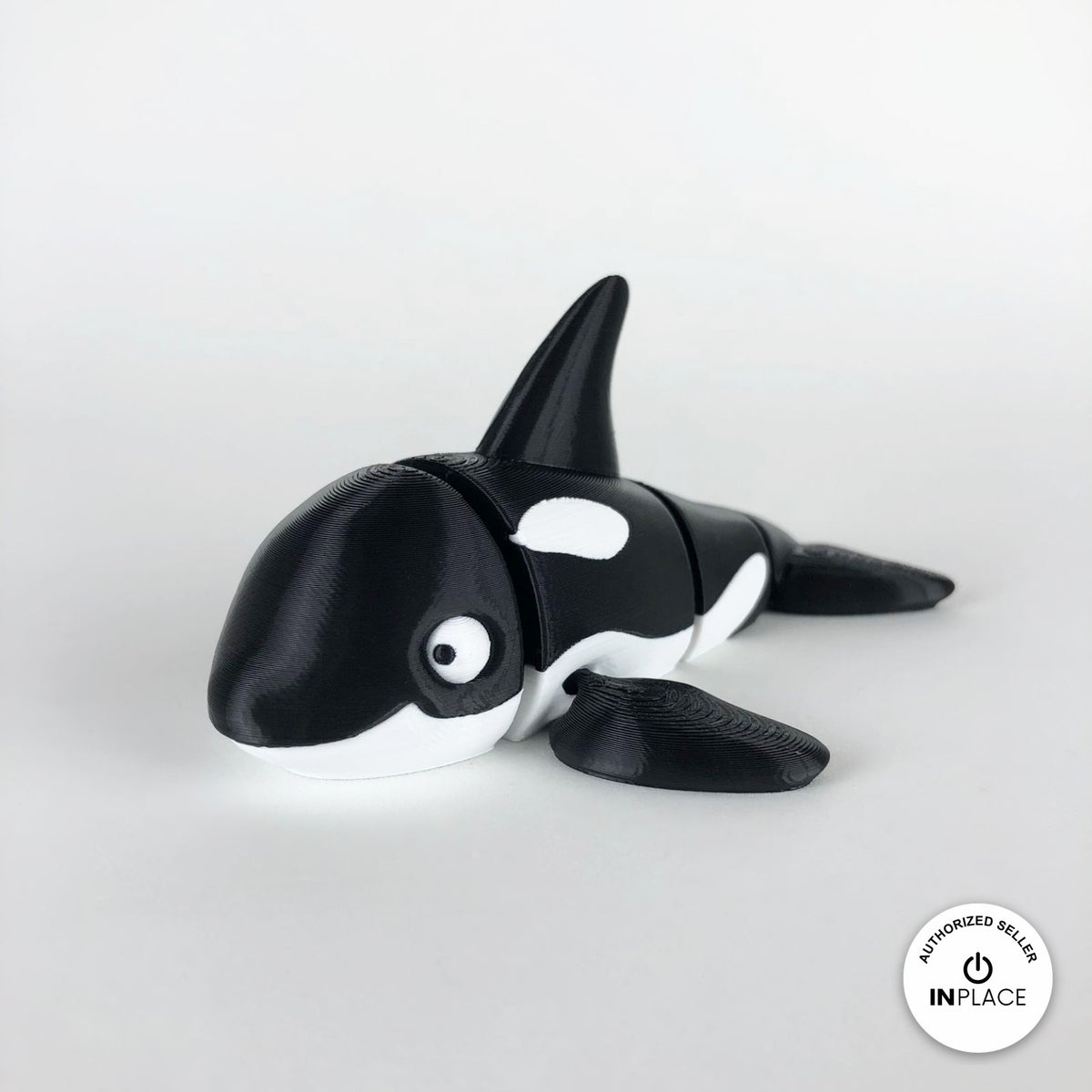 Cute orca killer whale keychain, 3D printed by RU3D – three quarter view facing left. Black and white.