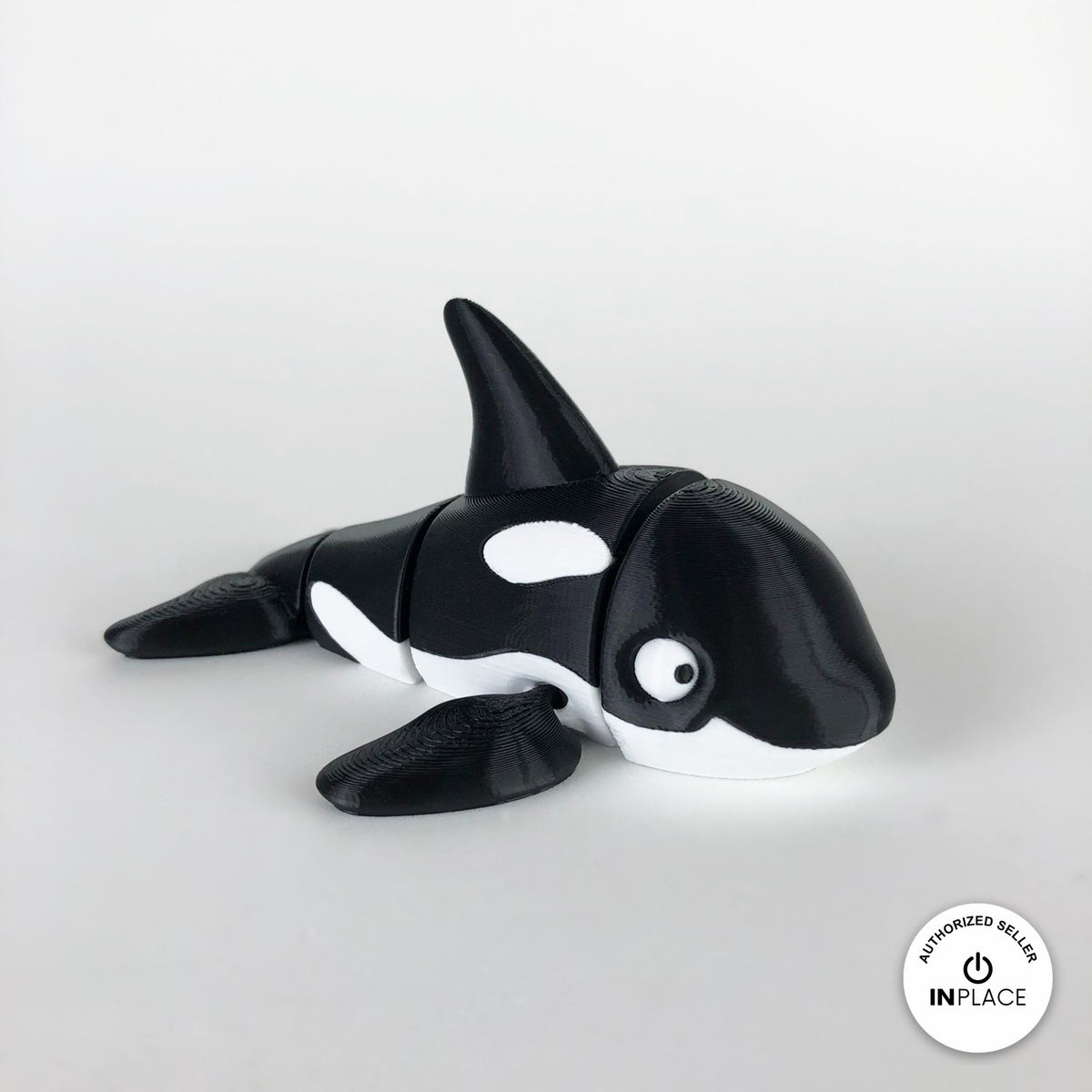 Cute orca killer whale keychain, 3D printed by RU3D – three quarter view facing right. Black and white.