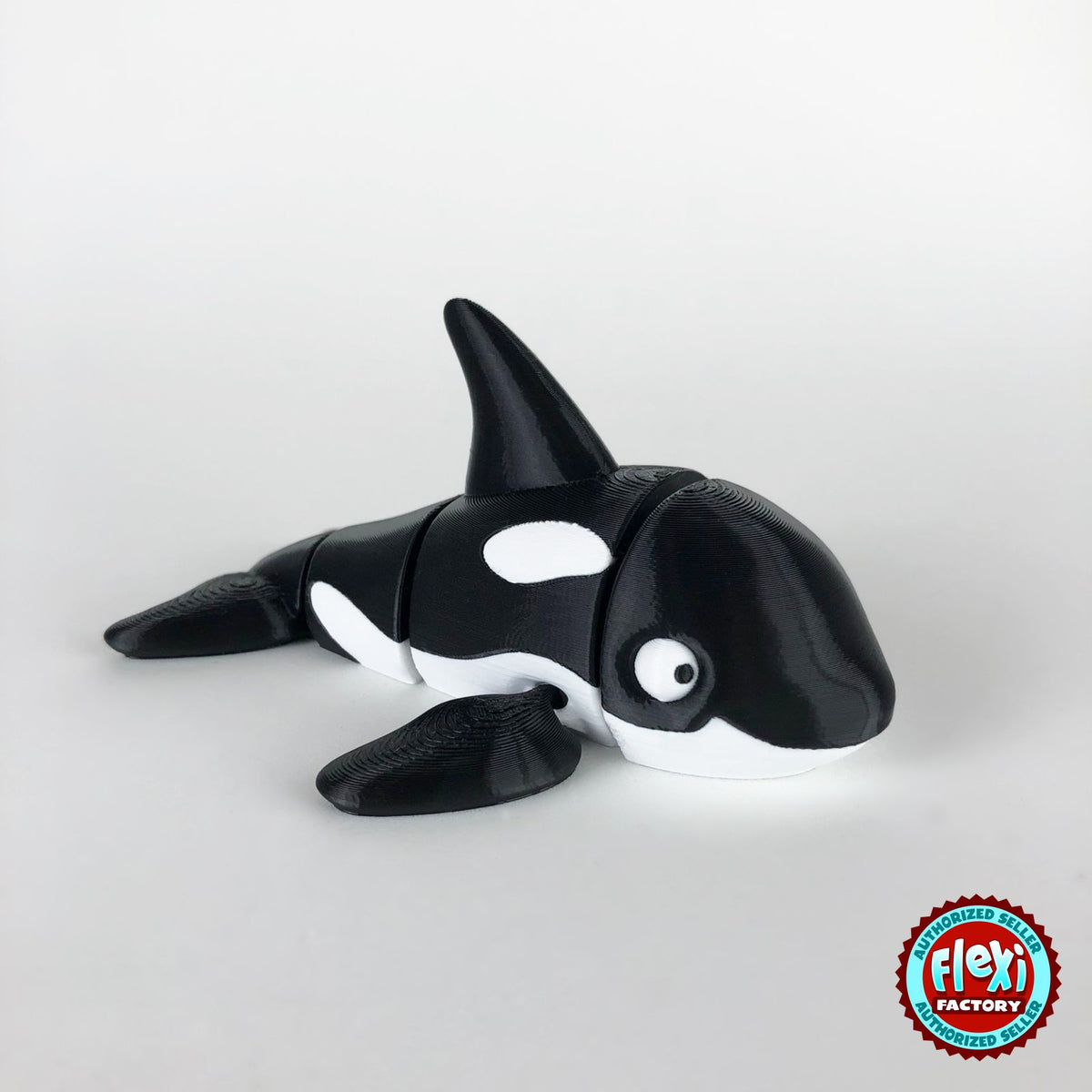 Cute orca killer whale keychain, 3D printed by RU3D – three quarter view facing right. Black and white.