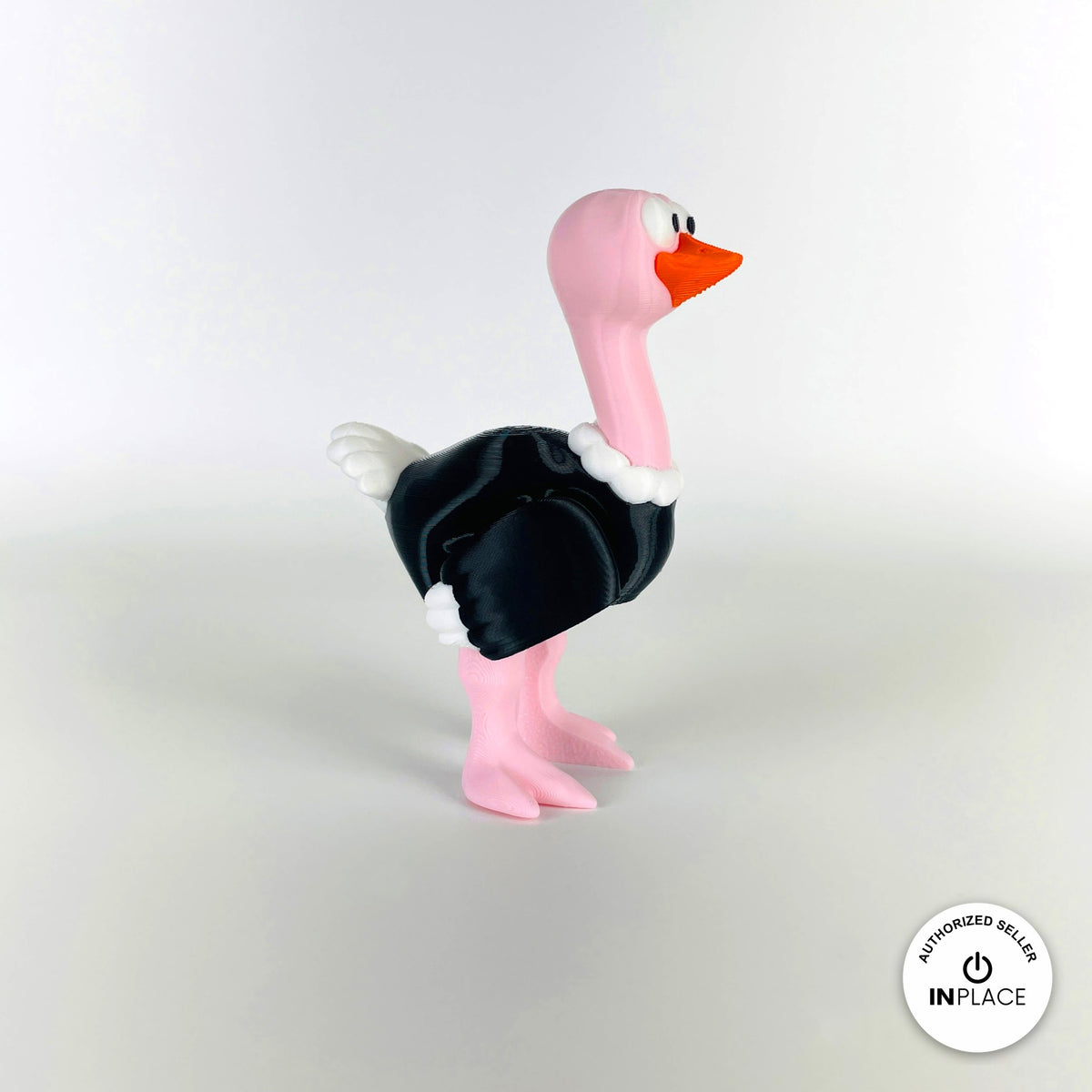 Cute ostrich keychain, 3D printed by RU3D – standing three quarter view facing right. Pink neck and legs with black feathers.