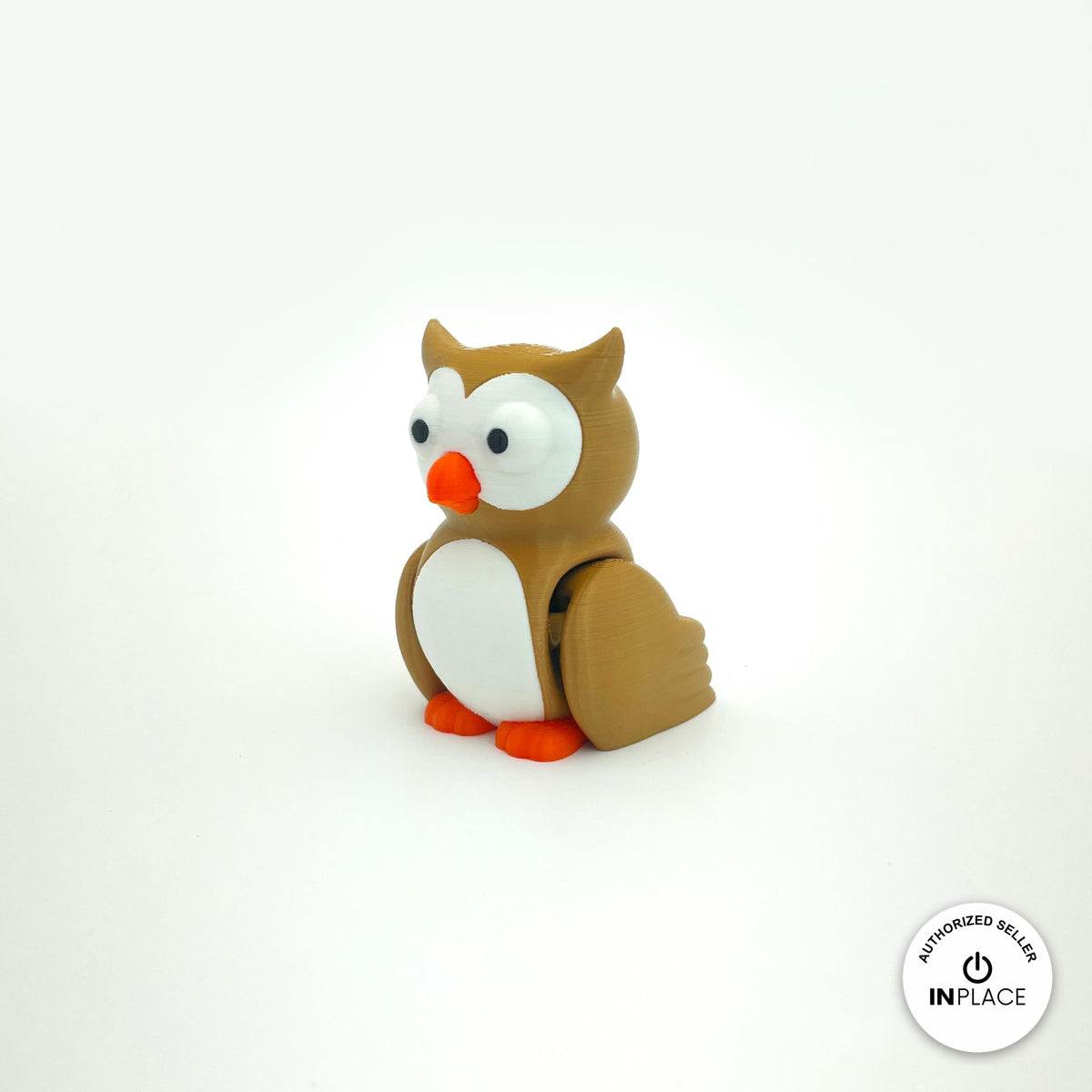 Cute owl keychain, 3D printed by RU3D – three quarter view facing left. Brown with white belly and orange beak, purple witch hat option.