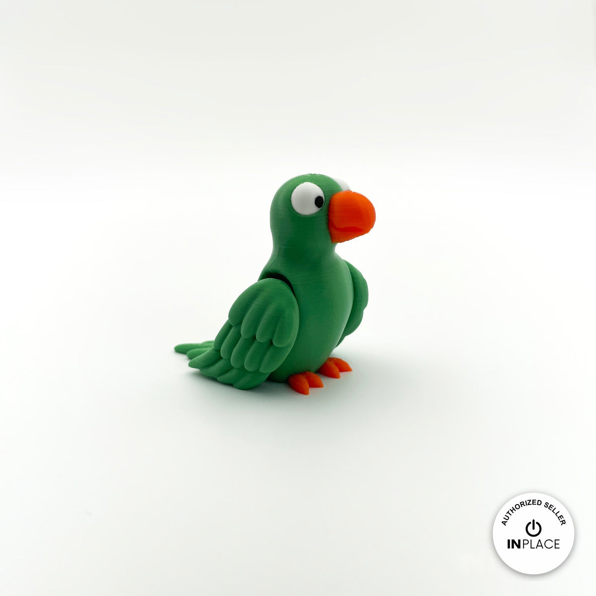 Cute parrot keychain, 3D printed by RU3D – green parrot three quarter view facing right. Green, blue and red macaw versions.