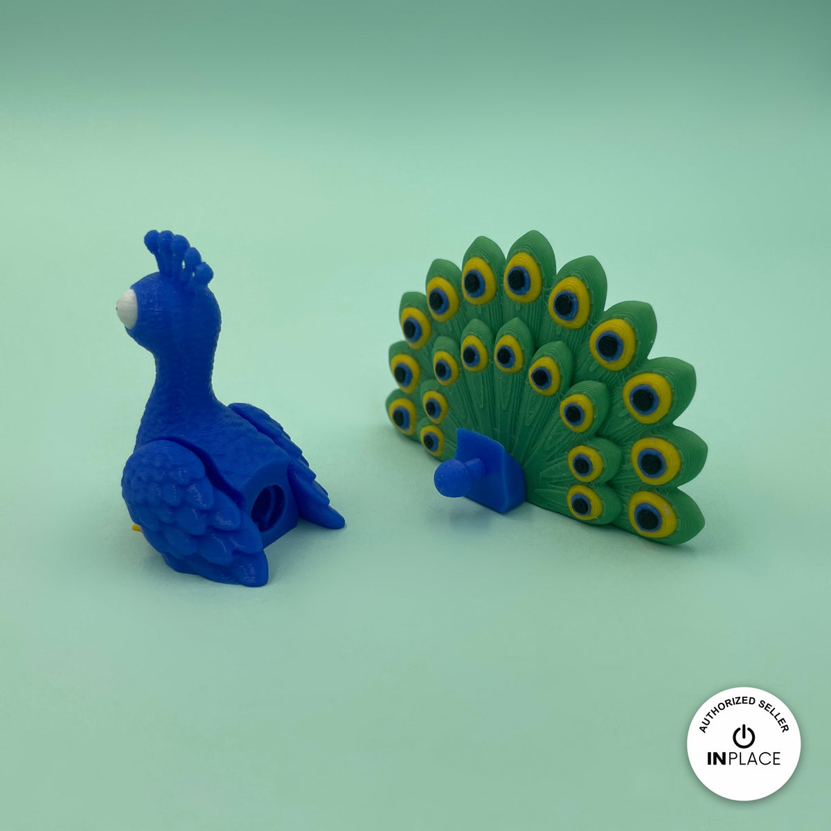 Cute peacock keychain, 3D printed by RU3D – with detachable tail feathers. Royal blue with green feather tail and pond garden playset.