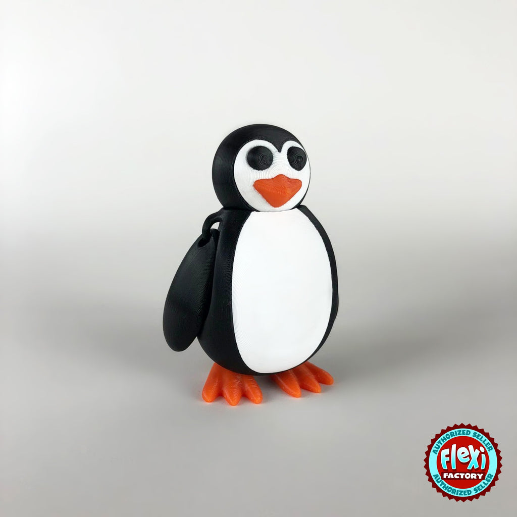 Cute penguin keychain, 3D printed by RU3D – dark eyes three quarter view facing left. Black and white with orange beak and feet.