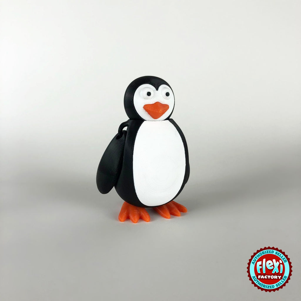 Cute penguin keychain, 3D printed by RU3D – three quarter view facing left. Black and white with orange beak and feet.