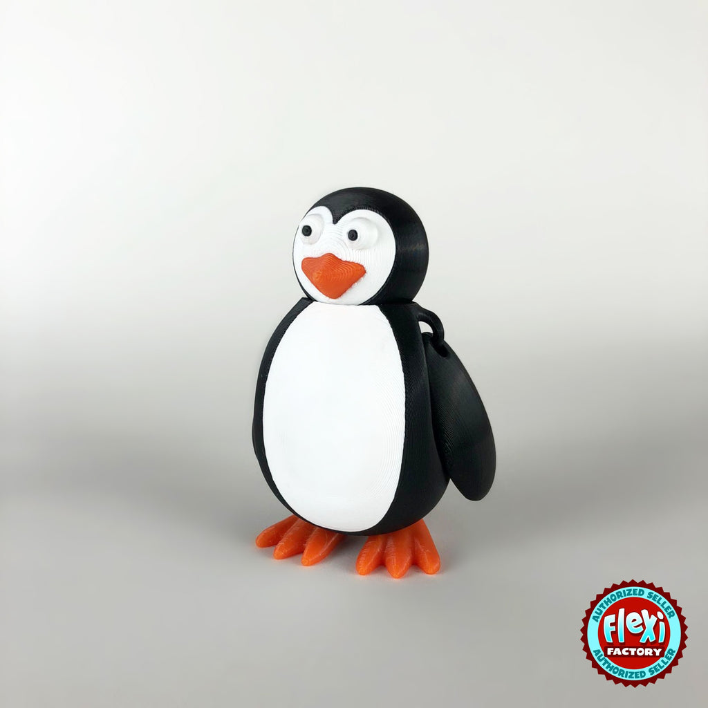 Cute penguin keychain, 3D printed by RU3D – three quarter view facing right. Black and white with orange beak and feet.