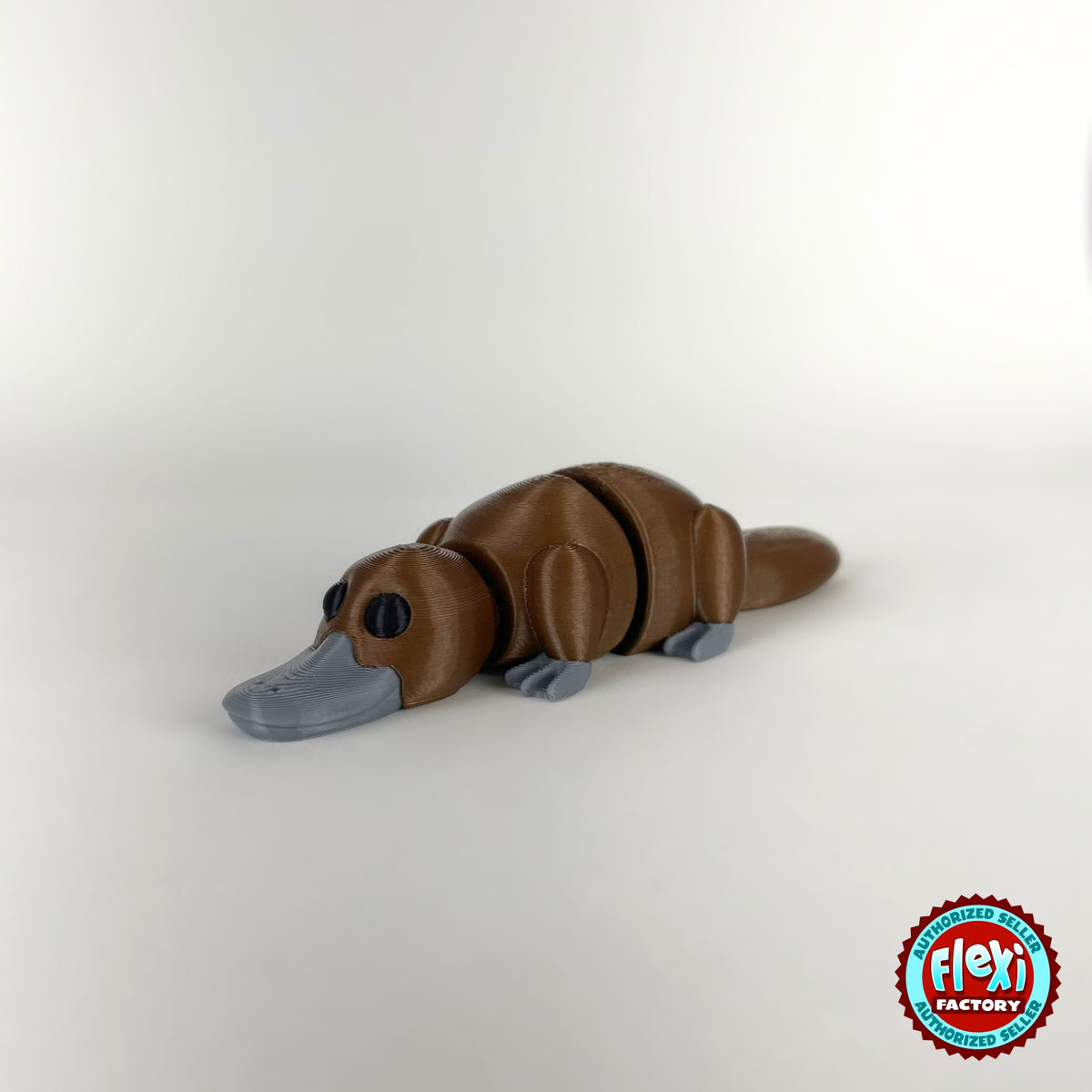 Cute platypus keychain, 3D printed by RU3D – brown dark eyes facing left. Brown with grey bill, also in cream.