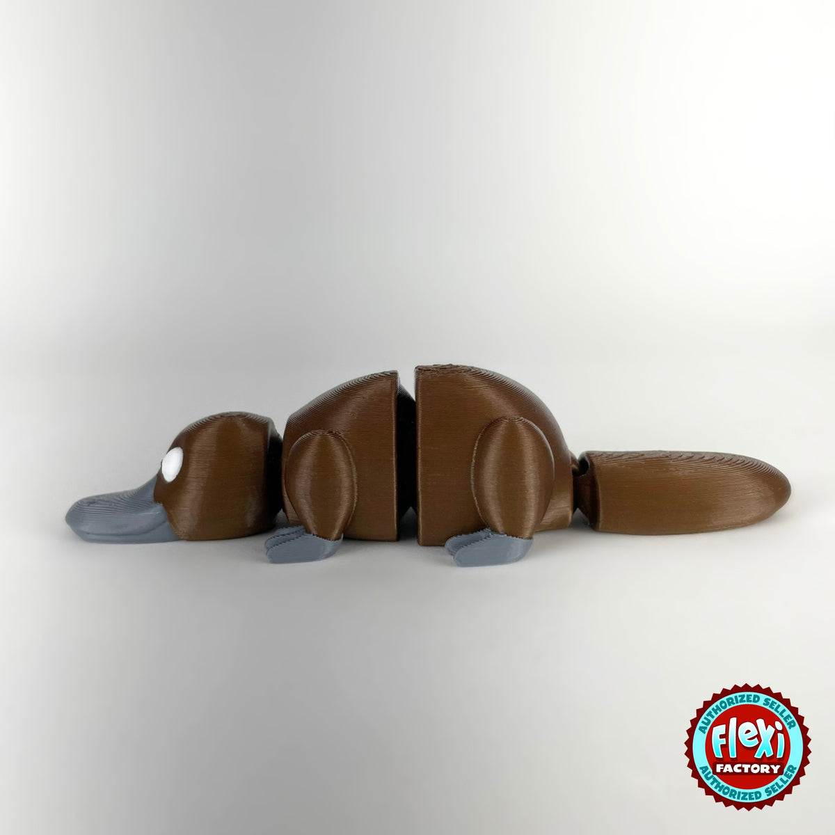 Cute platypus keychain, 3D printed by RU3D – brown side view facing left. Brown with grey bill, also in cream.