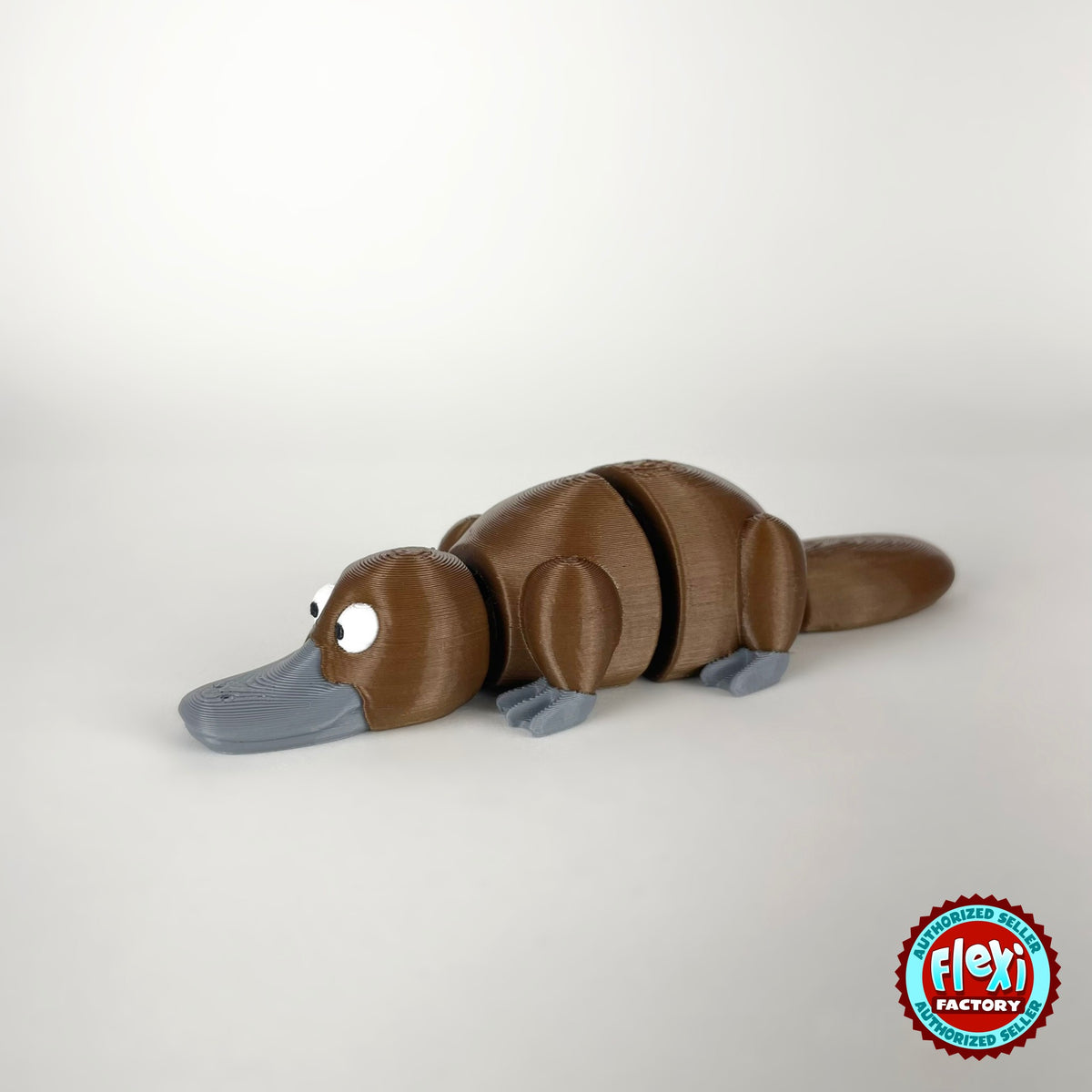 Cute platypus keychain, 3D printed by RU3D – brown three quarter view facing left. Brown with grey bill, also in cream.