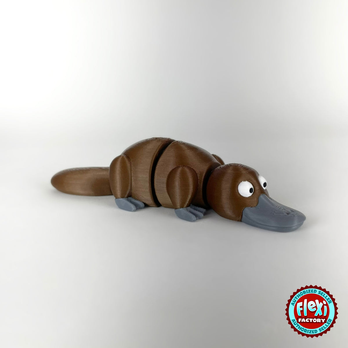 Cute platypus keychain, 3D printed by RU3D – brown three quarter view facing right. Brown with grey bill, also in cream.