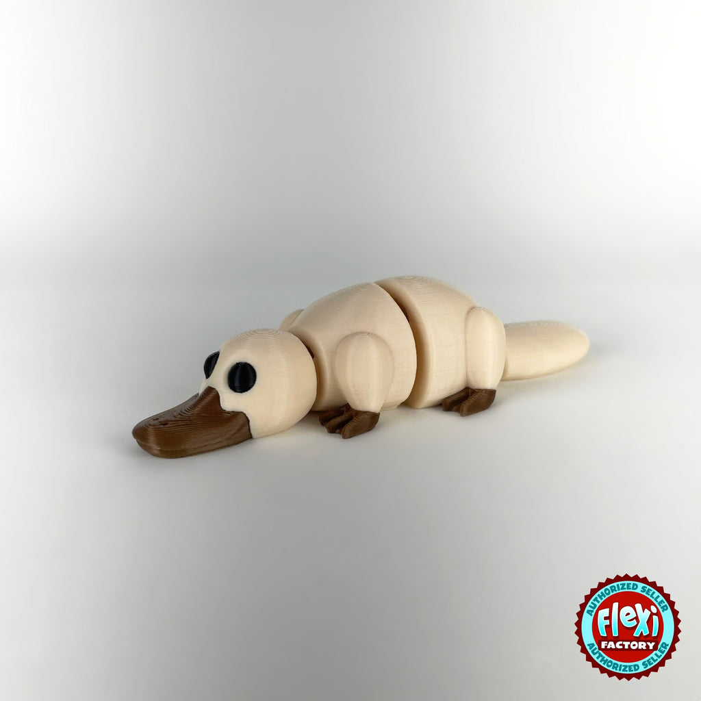 Cute platypus keychain, 3D printed by RU3D – cream dark eyes facing left. Brown with grey bill, also in cream.