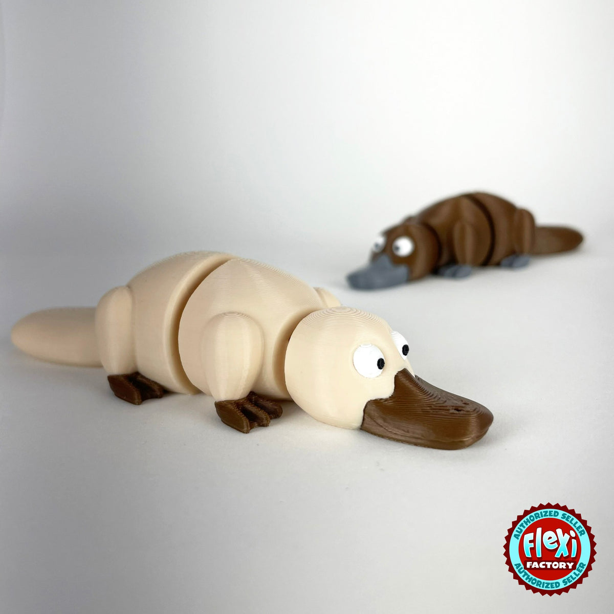 Cute platypus keychain, 3D printed by RU3D – cream platypus with brown behind. Brown with grey bill, also in cream.