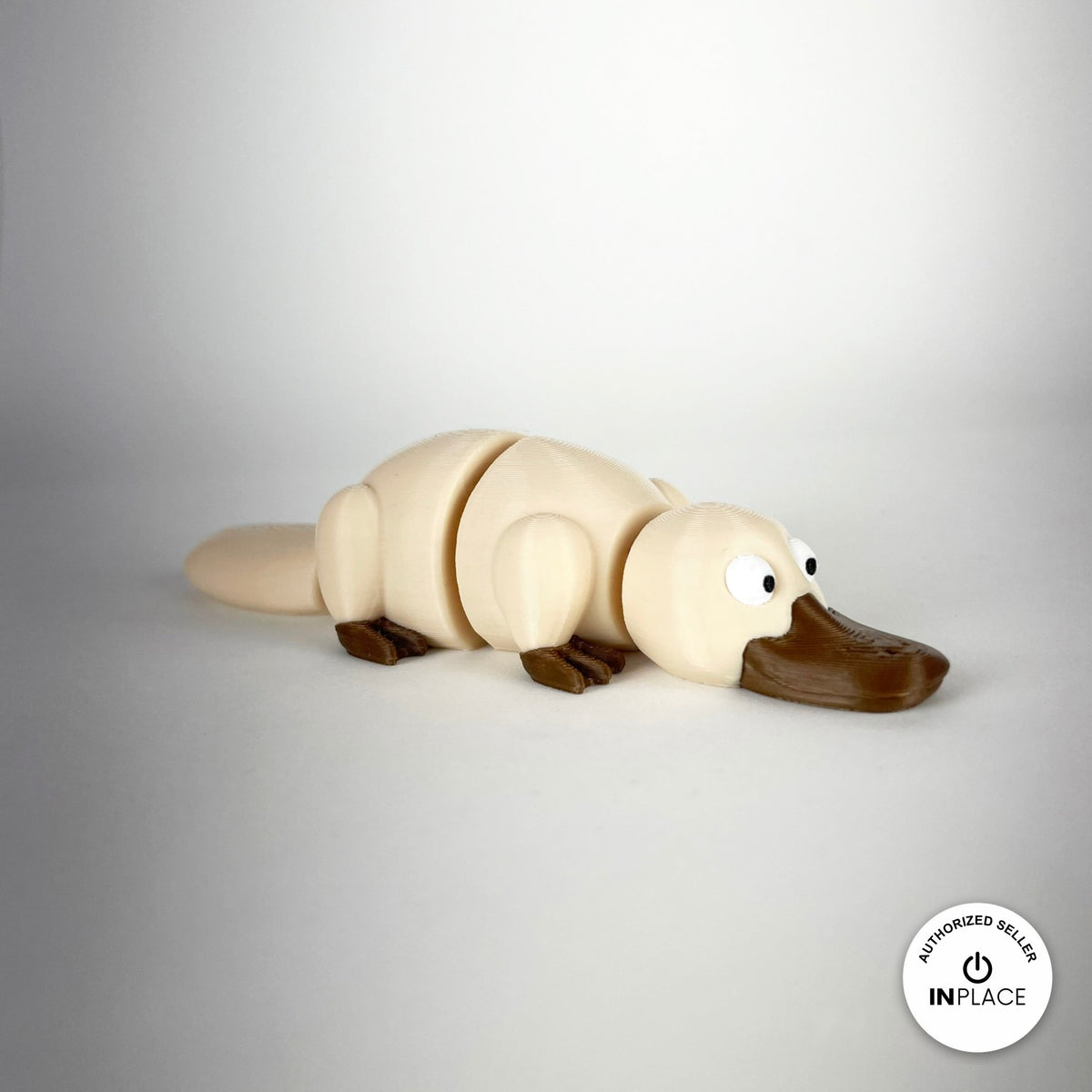 Cute platypus keychain, 3D printed by RU3D – cream three quarter view facing right. Brown with grey bill, also in cream.