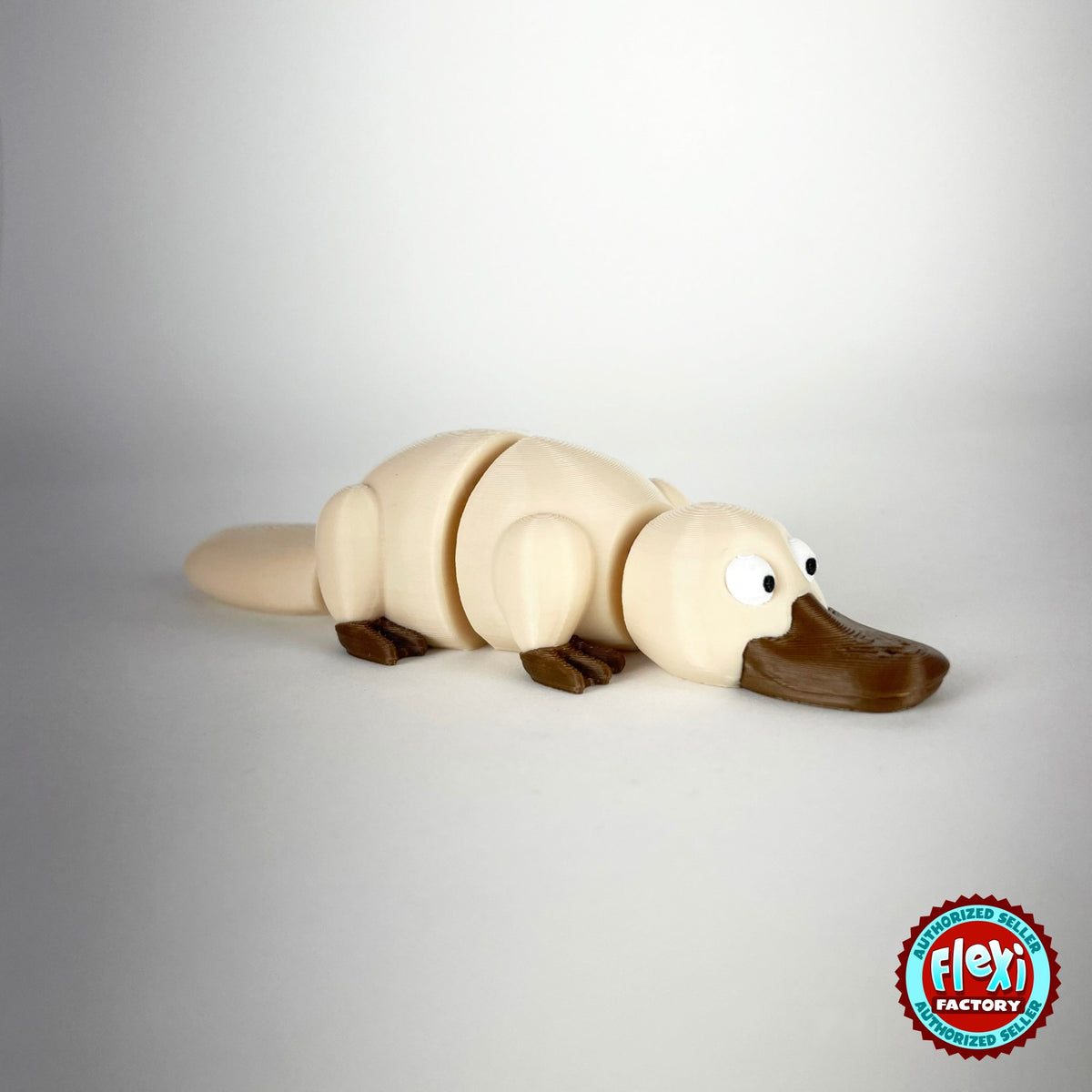 Cute platypus keychain, 3D printed by RU3D – cream three quarter view facing right. Brown with grey bill, also in cream.