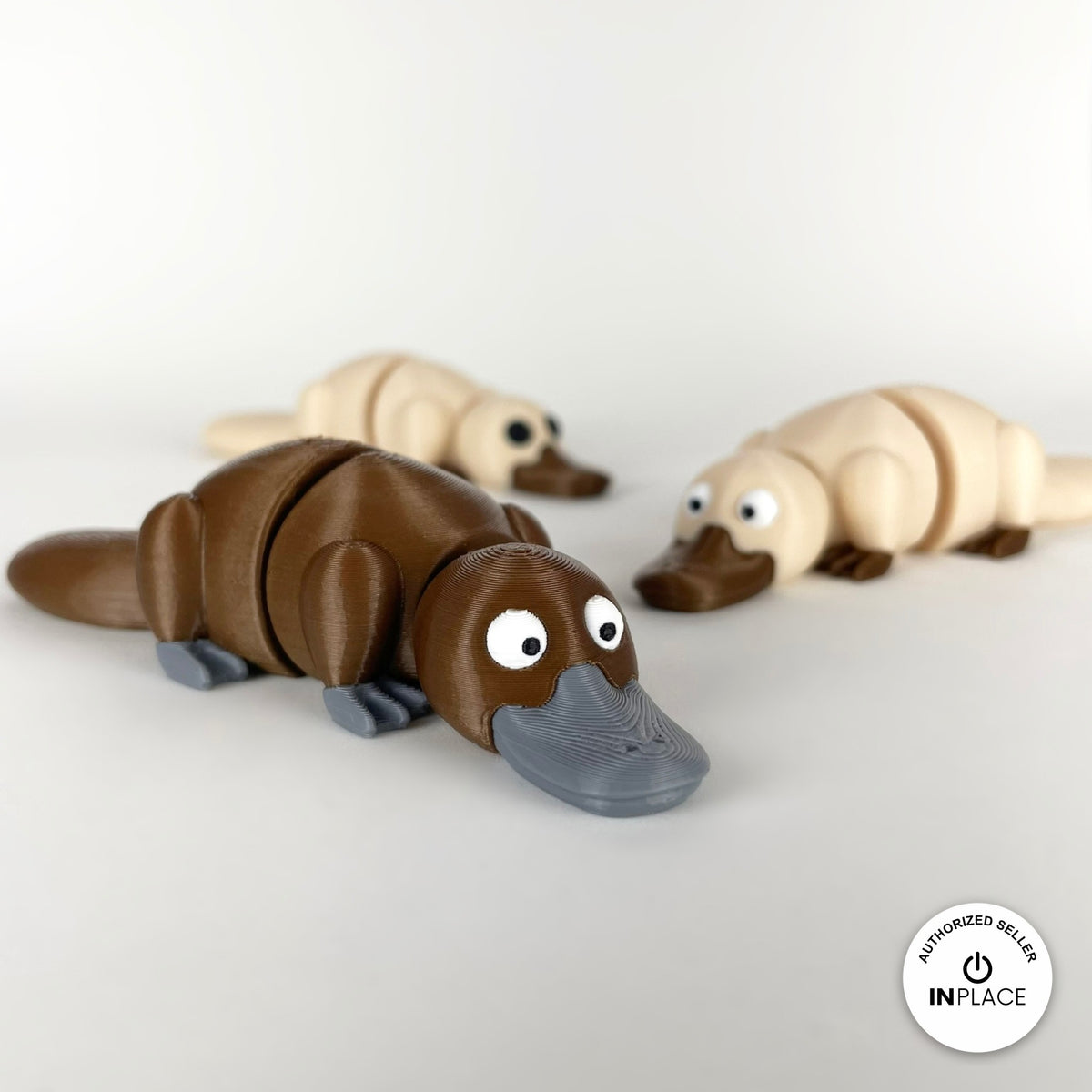 Cute platypus keychain, 3D printed by RU3D – group of platypuses. Brown with grey bill, also in cream.