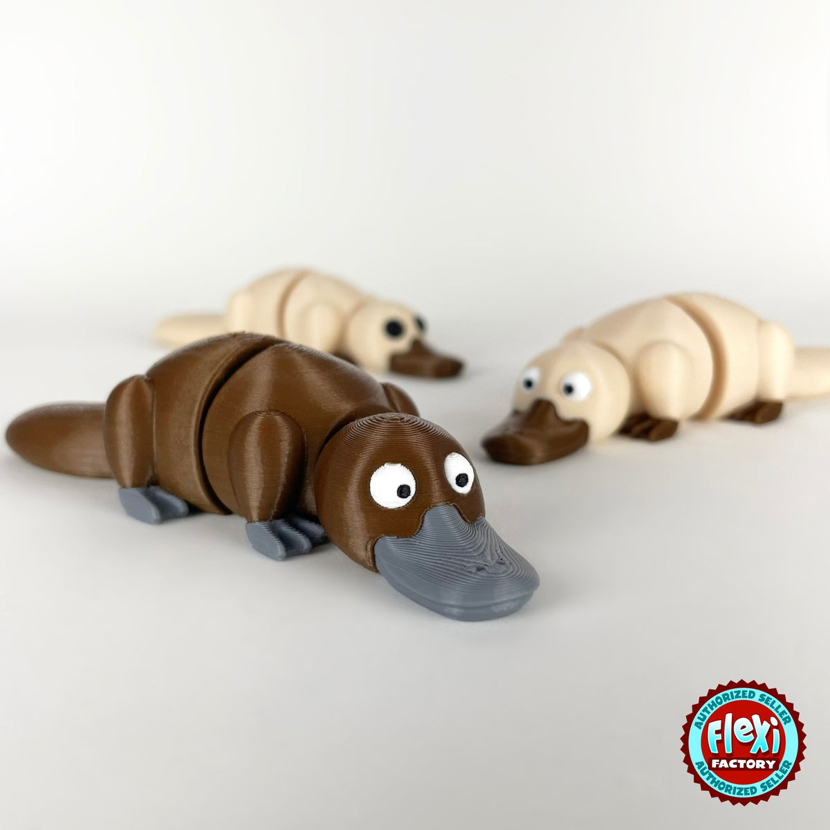 Cute platypus keychain, 3D printed by RU3D – group of platypuses. Brown with grey bill, also in cream.