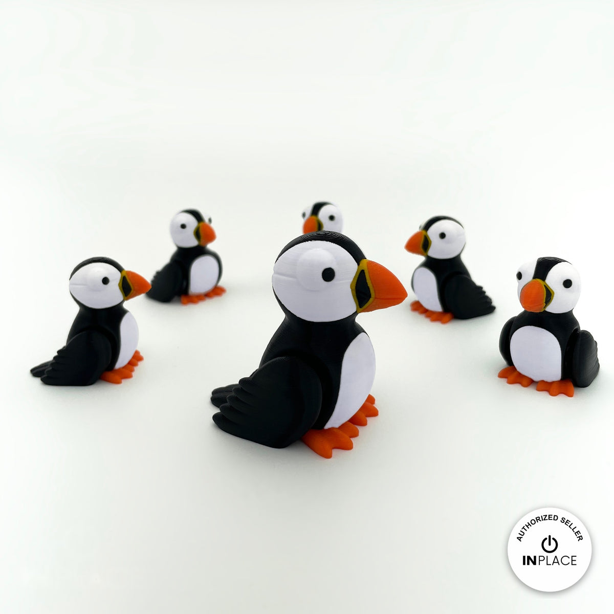 Cute puffin keychain, 3D printed by RU3D – group of puffins. Black and white with orange beak and feet.