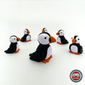 Cute puffin keychain, 3D printed by RU3D – group of puffins. Black and white with orange beak and feet.