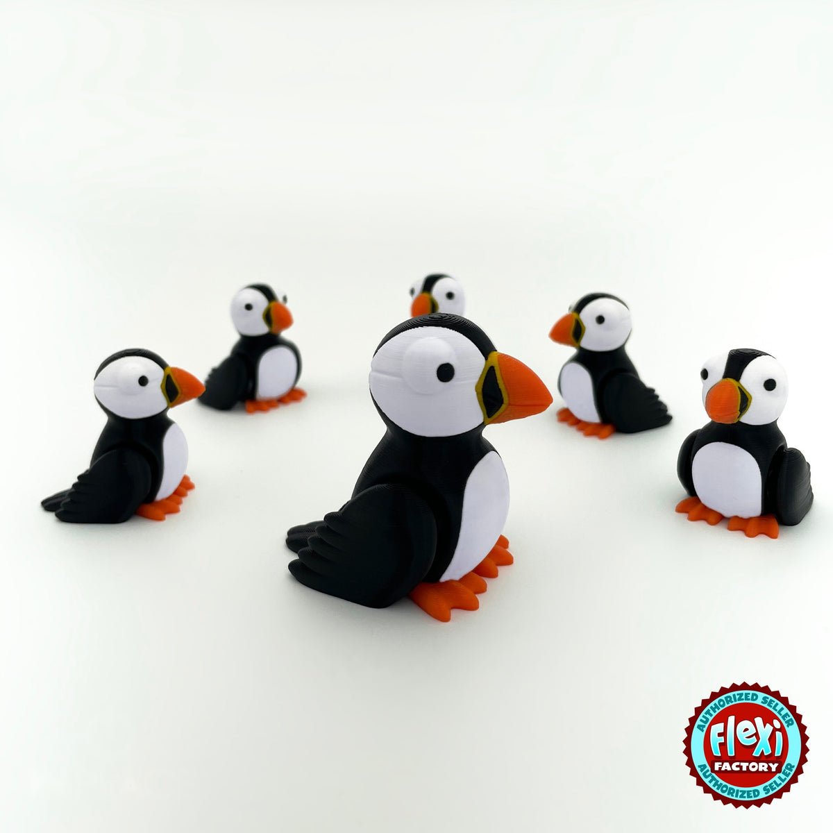Cute puffin keychain, 3D printed by RU3D – group of puffins. Black and white with orange beak and feet.
