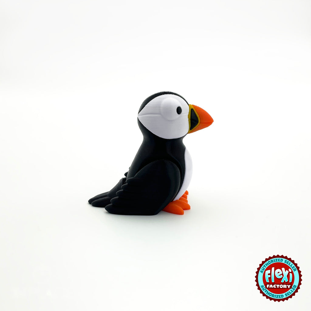 Cute puffin keychain, 3D printed by RU3D – three quarter view facing right. Black and white with orange beak and feet.