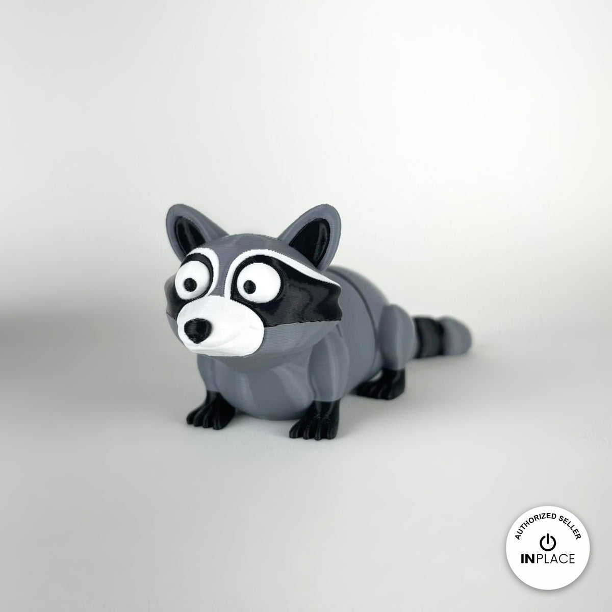 Cute raccoon keychain, 3D printed by RU3D – three quarter view facing left. Grey and black with trash can playset.