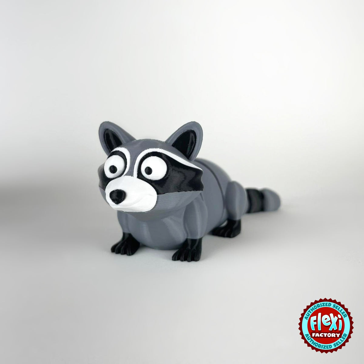 Cute raccoon keychain, 3D printed by RU3D – three quarter view facing left. Grey and black with trash can playset.