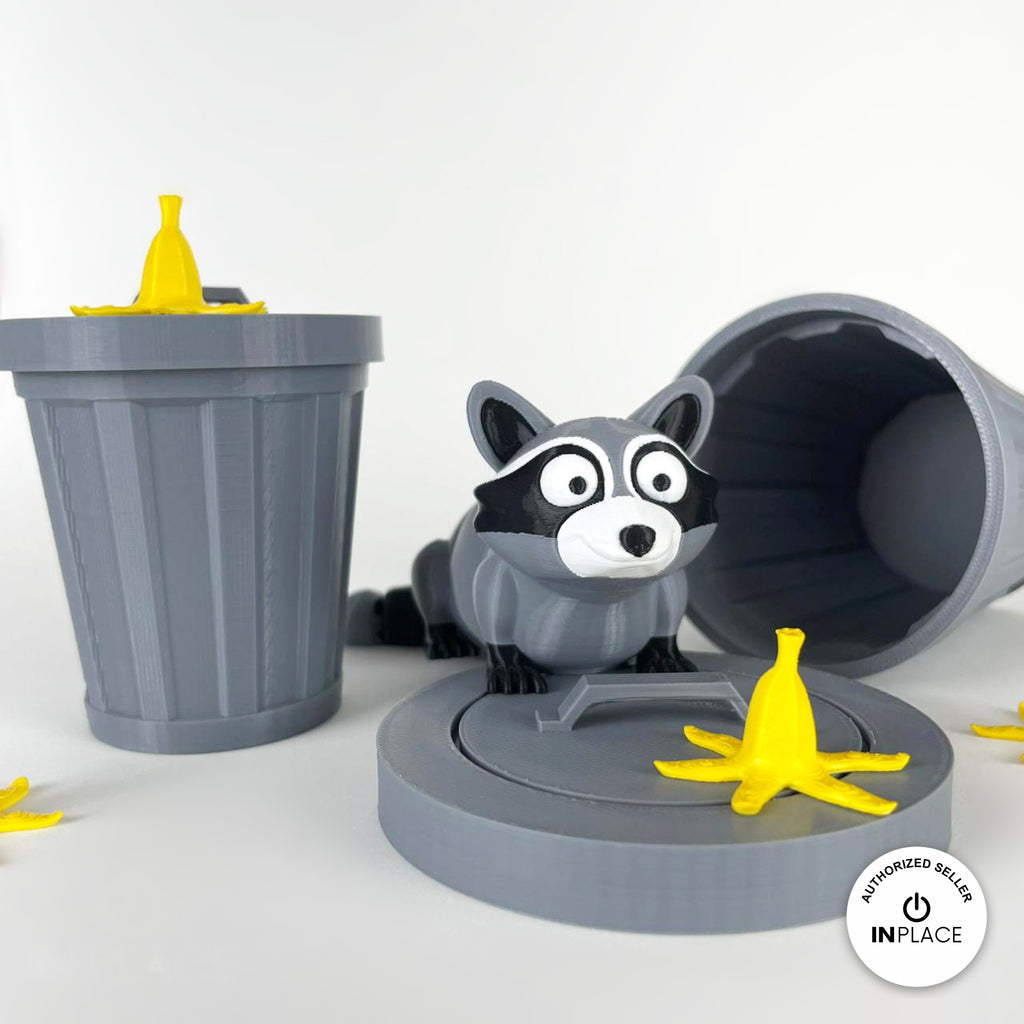 3D printed banana peel accessory by RU3D, shown with the Raccoon keychain