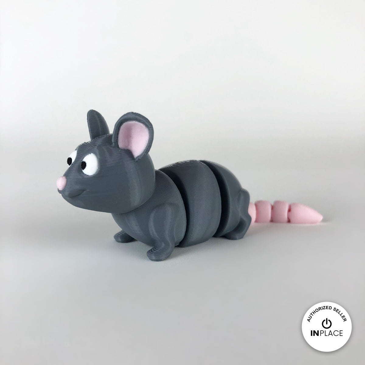 Cute rat keychain, 3D printed by RU3D – three quarter view facing left. Grey with pink ears and tail.