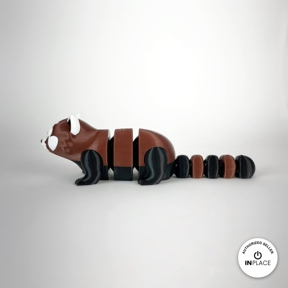 Cute red panda keychain, 3D printed by RU3D – side view facing left. Reddish brown, black and white.