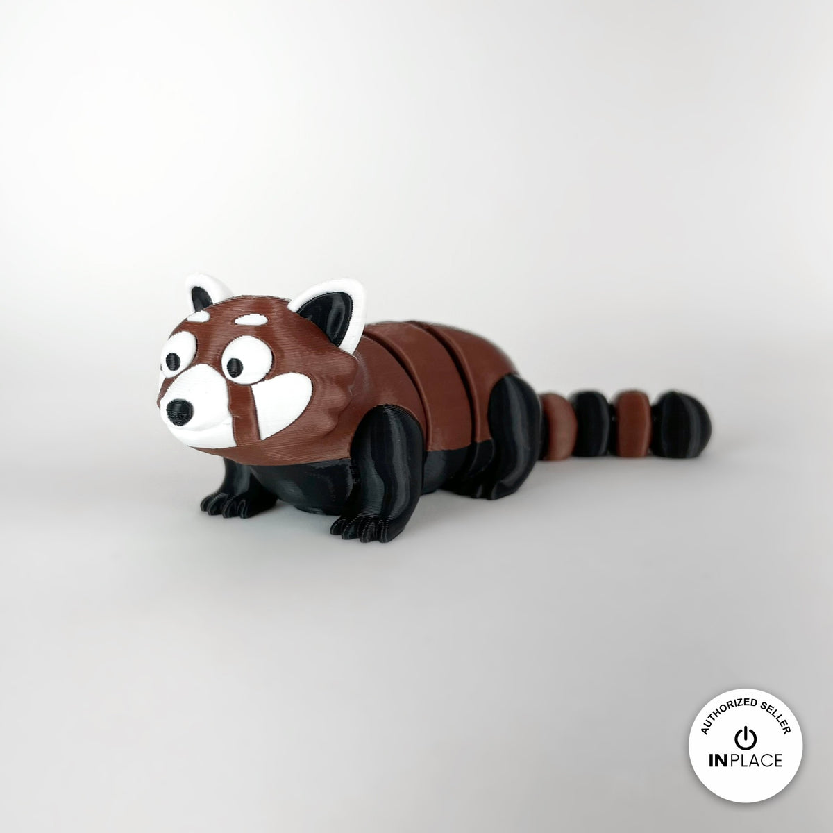 Cute red panda keychain, 3D printed by RU3D – three quarter view facing left. Reddish brown, black and white.