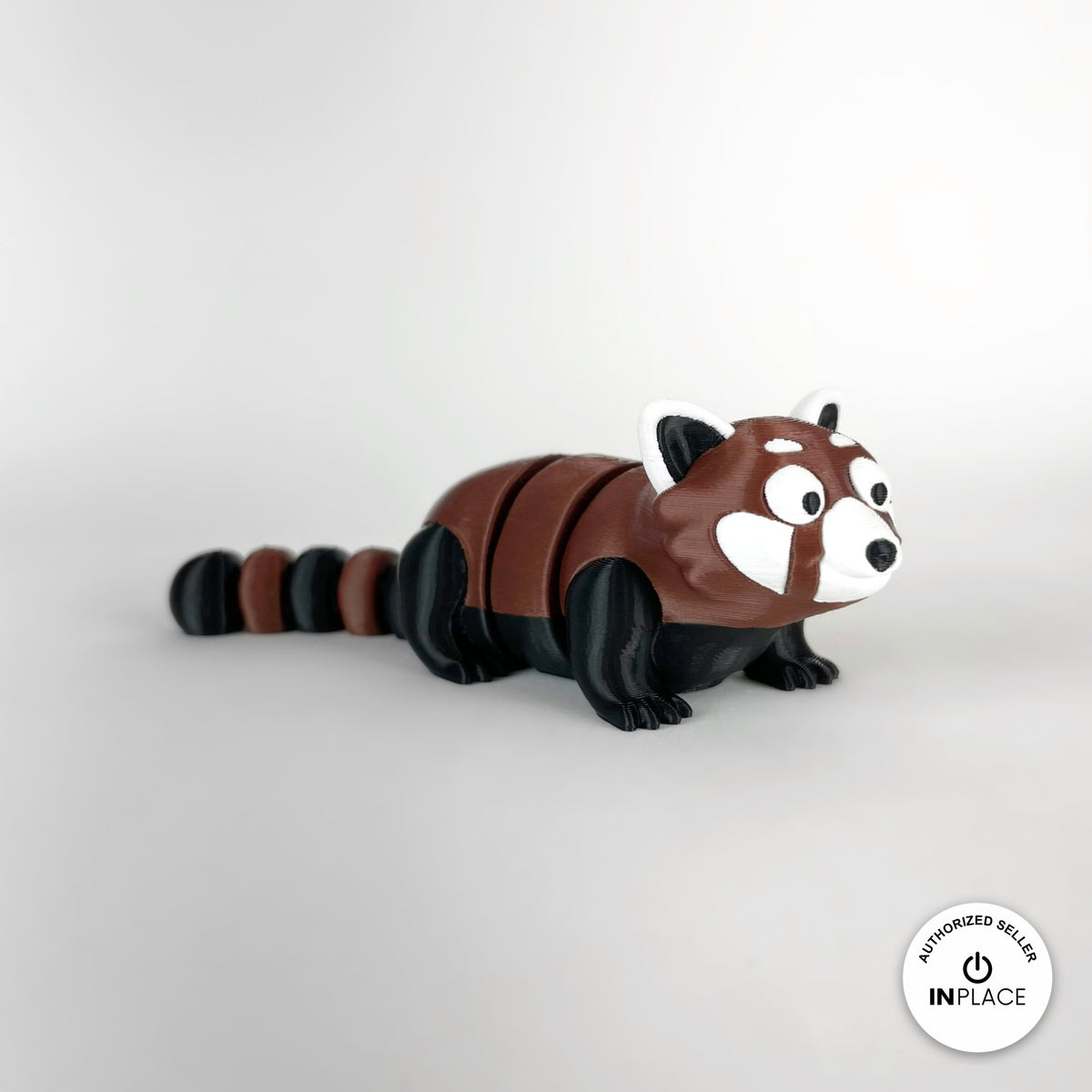 Cute red panda keychain, 3D printed by RU3D – three quarter view facing right. Reddish brown, black and white.