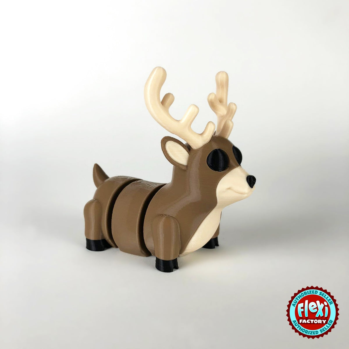 Cute reindeer keychain, 3D printed by RU3D – dark eyes three quarter view facing right. Brown with cream antlers and chest.