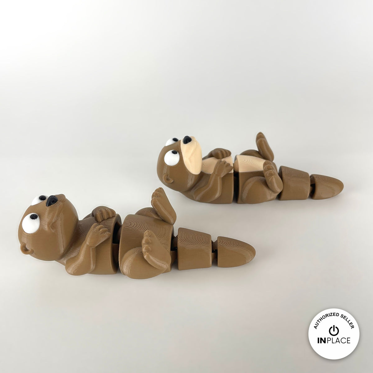 Cute river otter keychain, 3D printed by RU3D – pair of otters lying down. Brown with cream belly.
