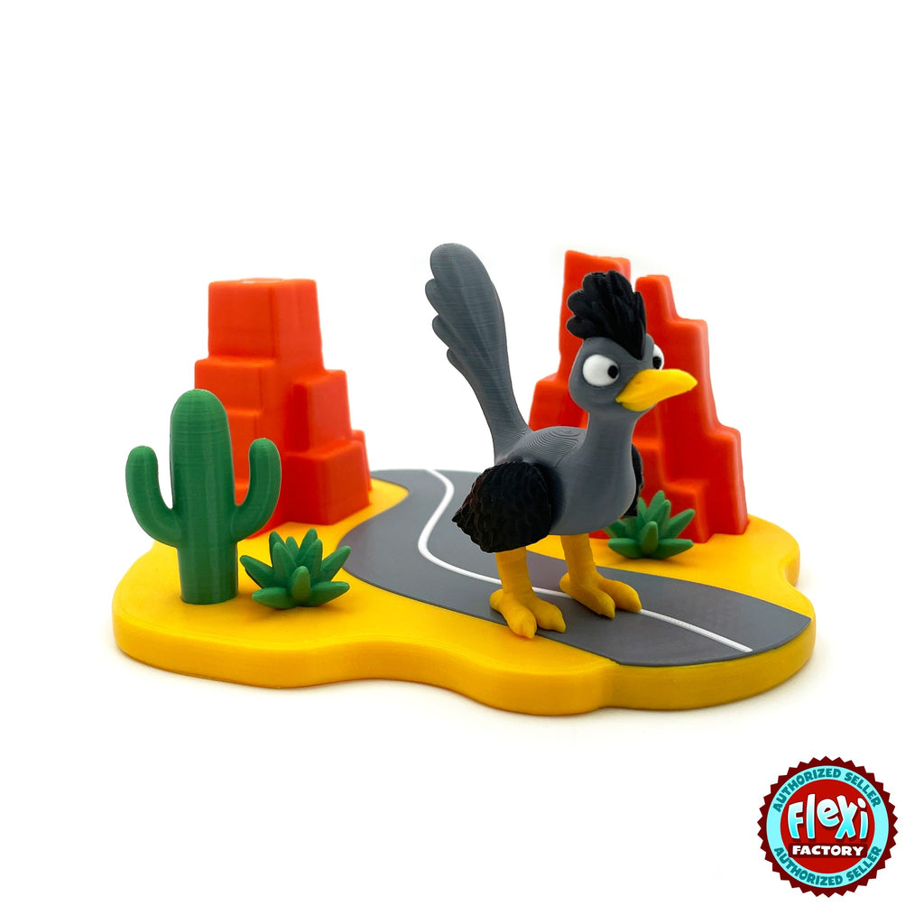 Cute road runner keychain, 3D printed by RU3D – three quarter view on desert highway. Grey and black bird with desert highway playset.