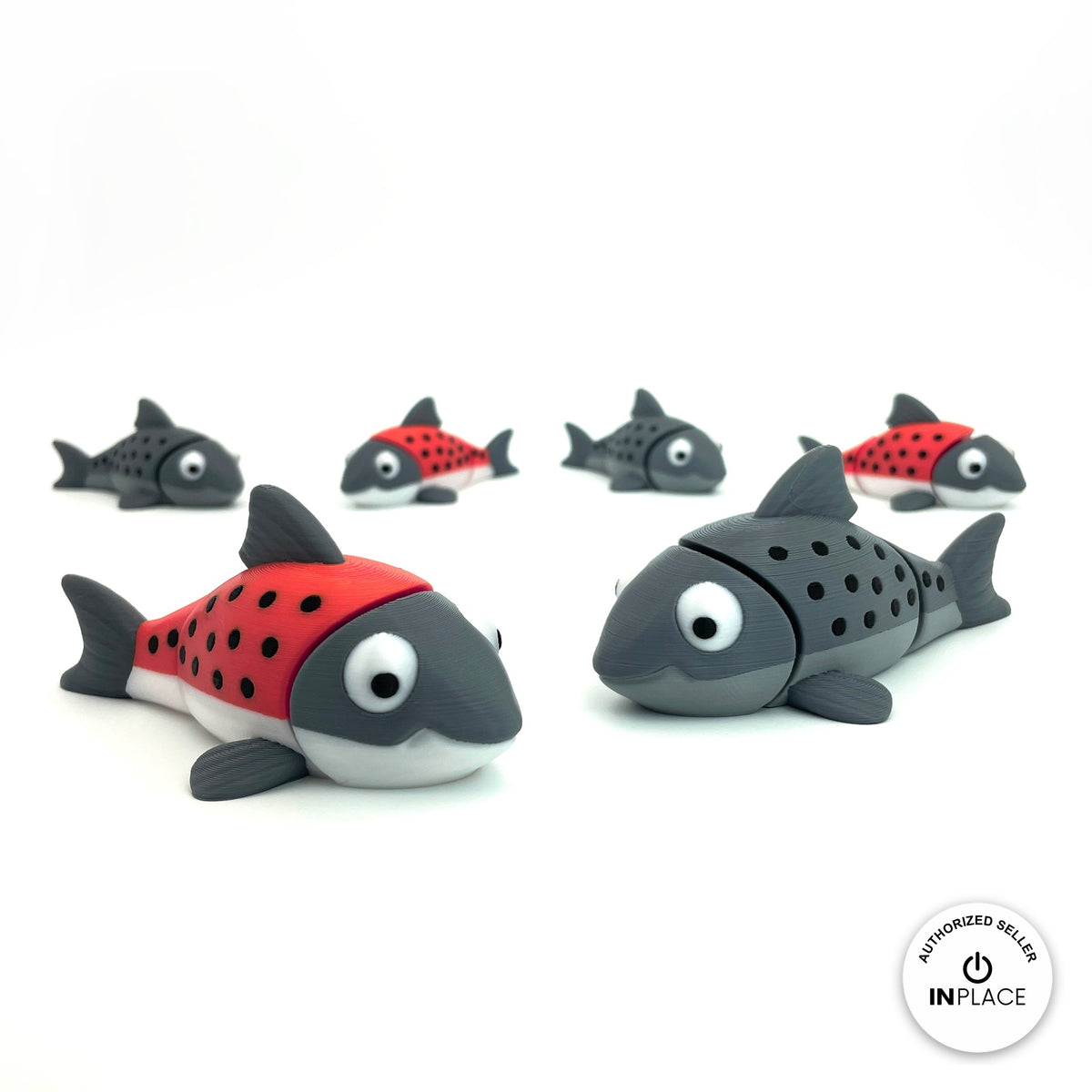 Cute salmon fish keychain, 3D printed by RU3D – group of salmon. Red and grey with black spots, also all grey.
