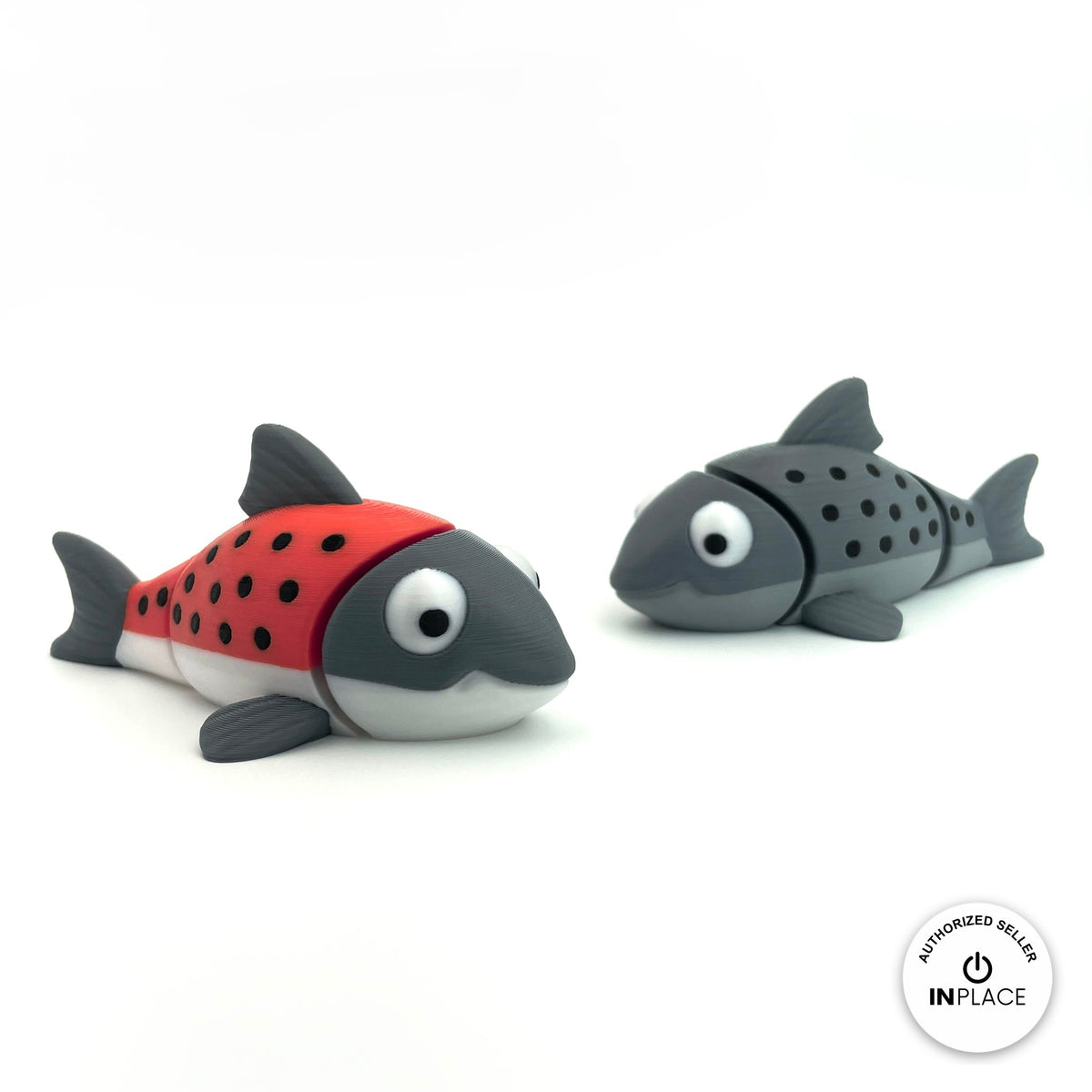 Cute salmon fish keychain, 3D printed by RU3D – red and grey salmon pair. Red and grey with black spots, also all grey.