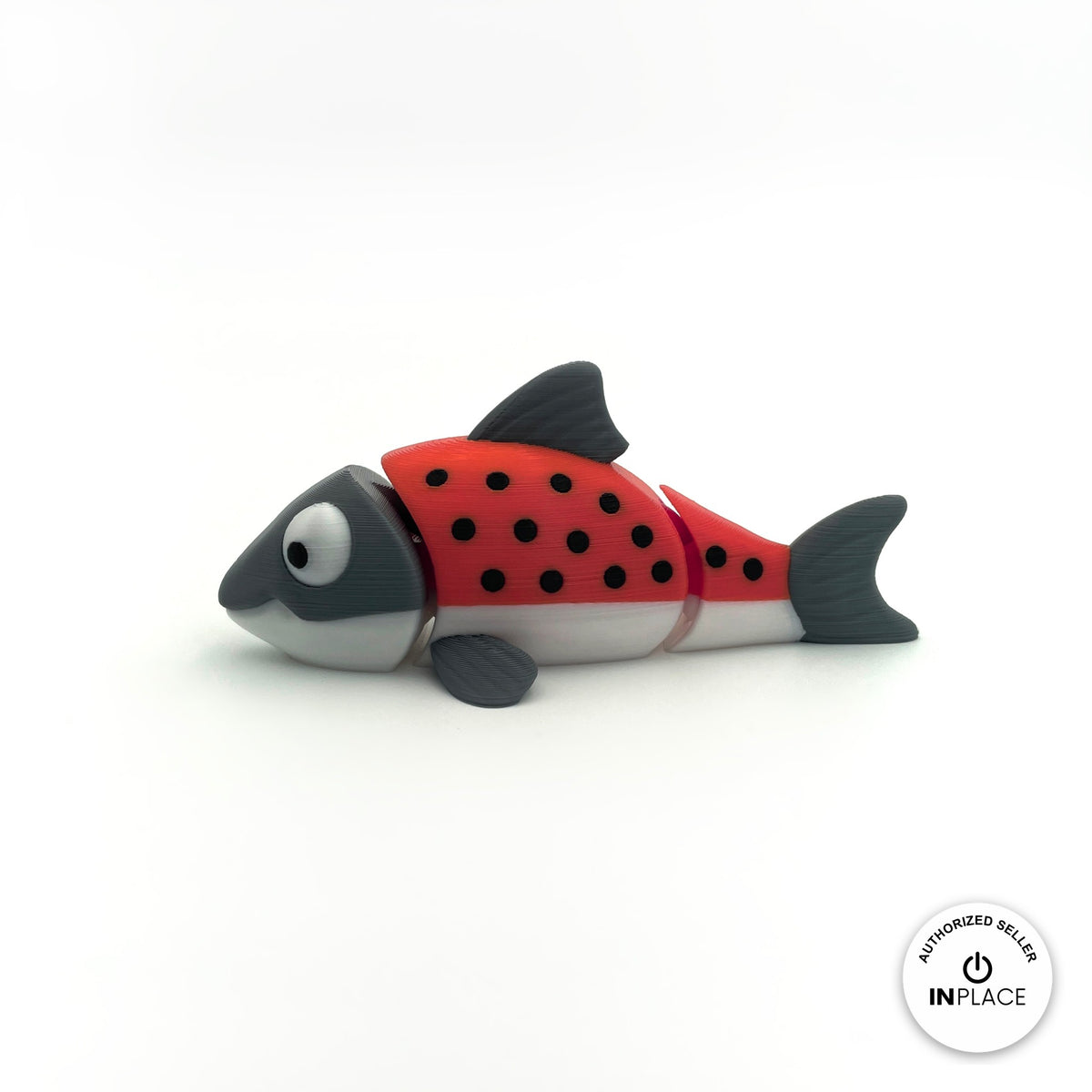 Cute salmon fish keychain, 3D printed by RU3D – red salmon side view facing left. Red and grey with black spots, also all grey.
