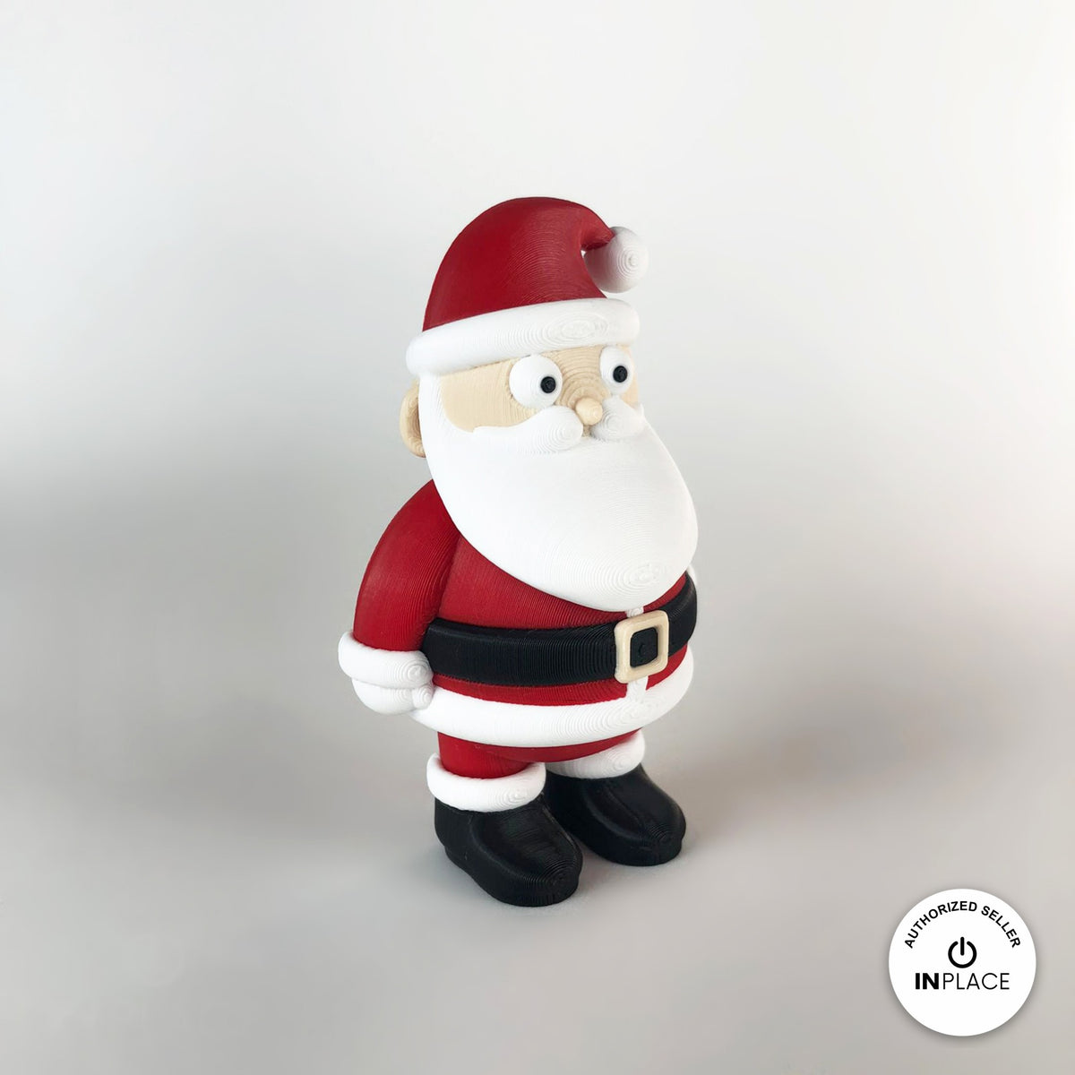 Cute Santa claus keychain, 3D printed by RU3D – three quarter view facing left. Red suit with white beard and black boots.