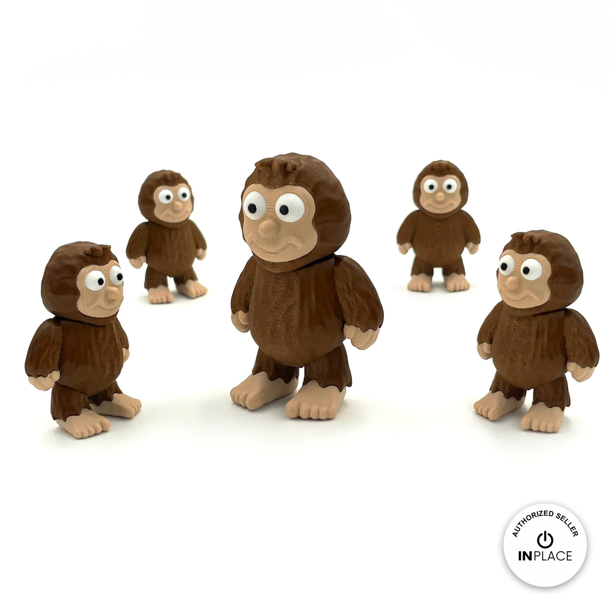 Cute sasquatch Bigfoot keychain, 3D printed by RU3D – group of sasquatches. Dark brown fur with tan face and feet.