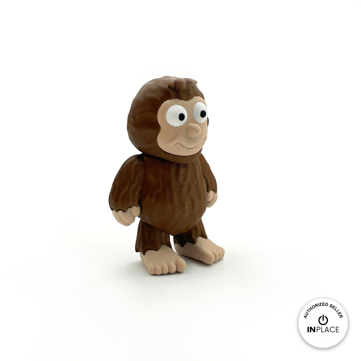 Cute sasquatch Bigfoot keychain, 3D printed by RU3D – three quarter view facing right. Dark brown fur with tan face and feet.