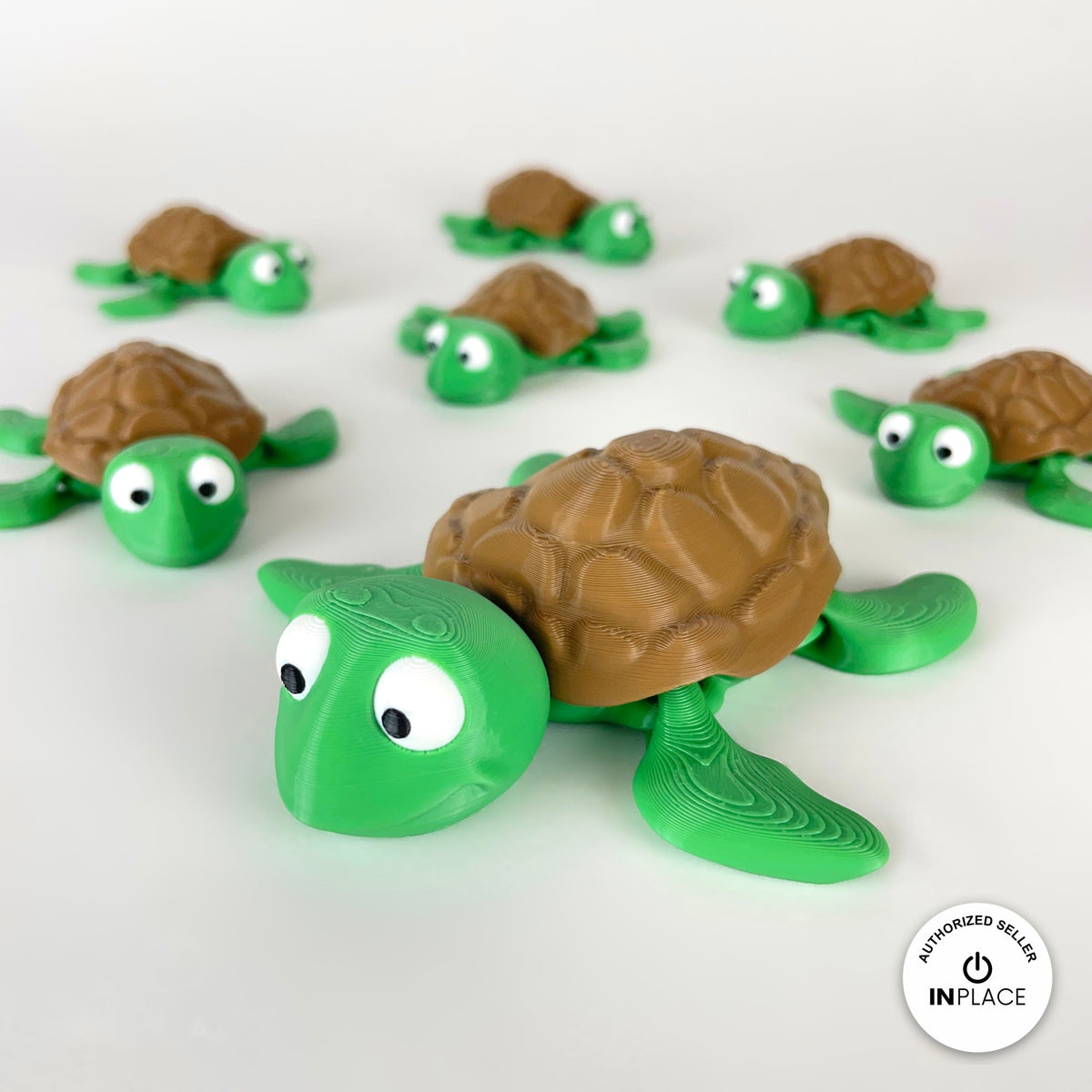 Cute sea turtle keychain, 3D printed by RU3D – group of sea turtles facing left. Green with brown shell.