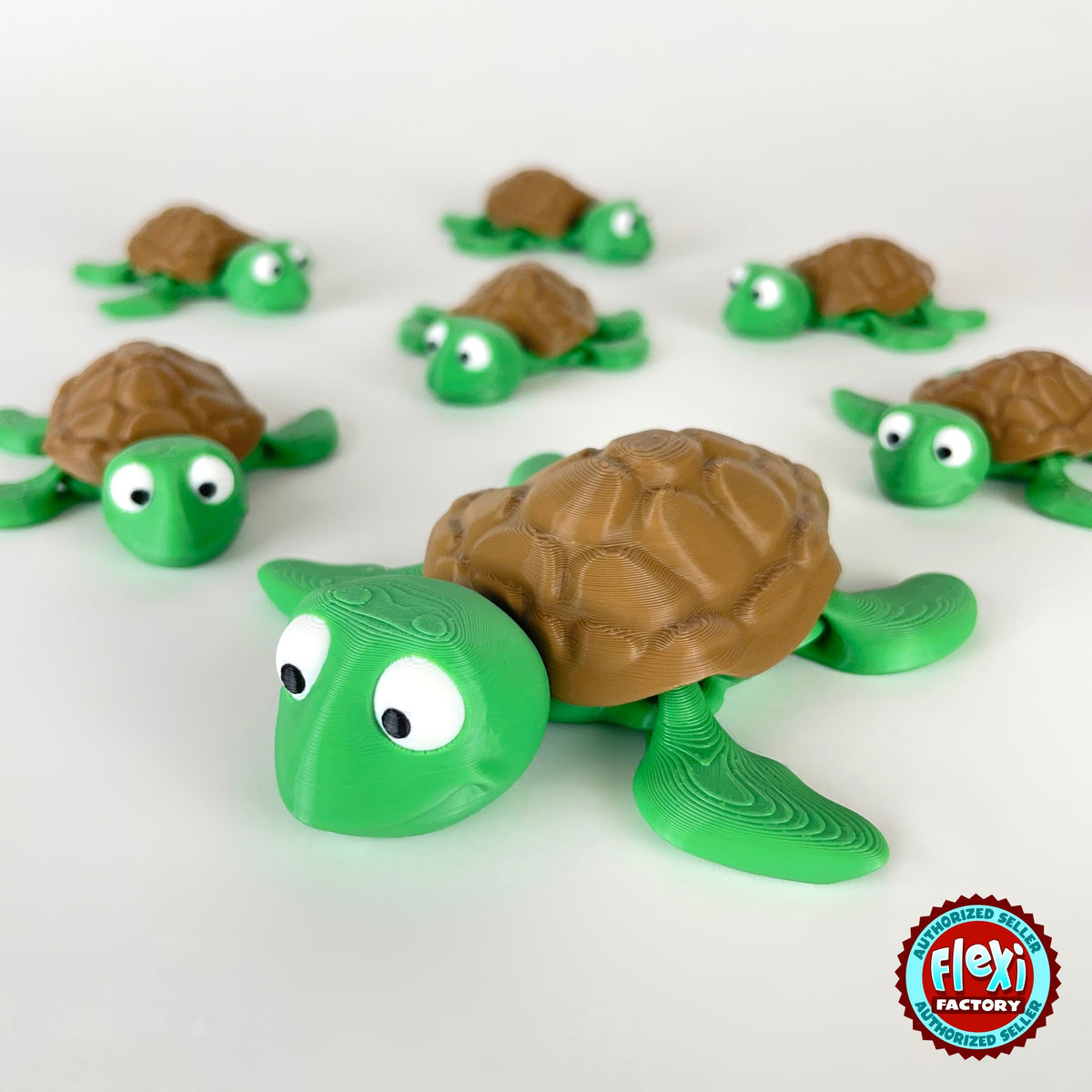 Cute sea turtle keychain, 3D printed by RU3D – group of sea turtles facing left. Green with brown shell.
