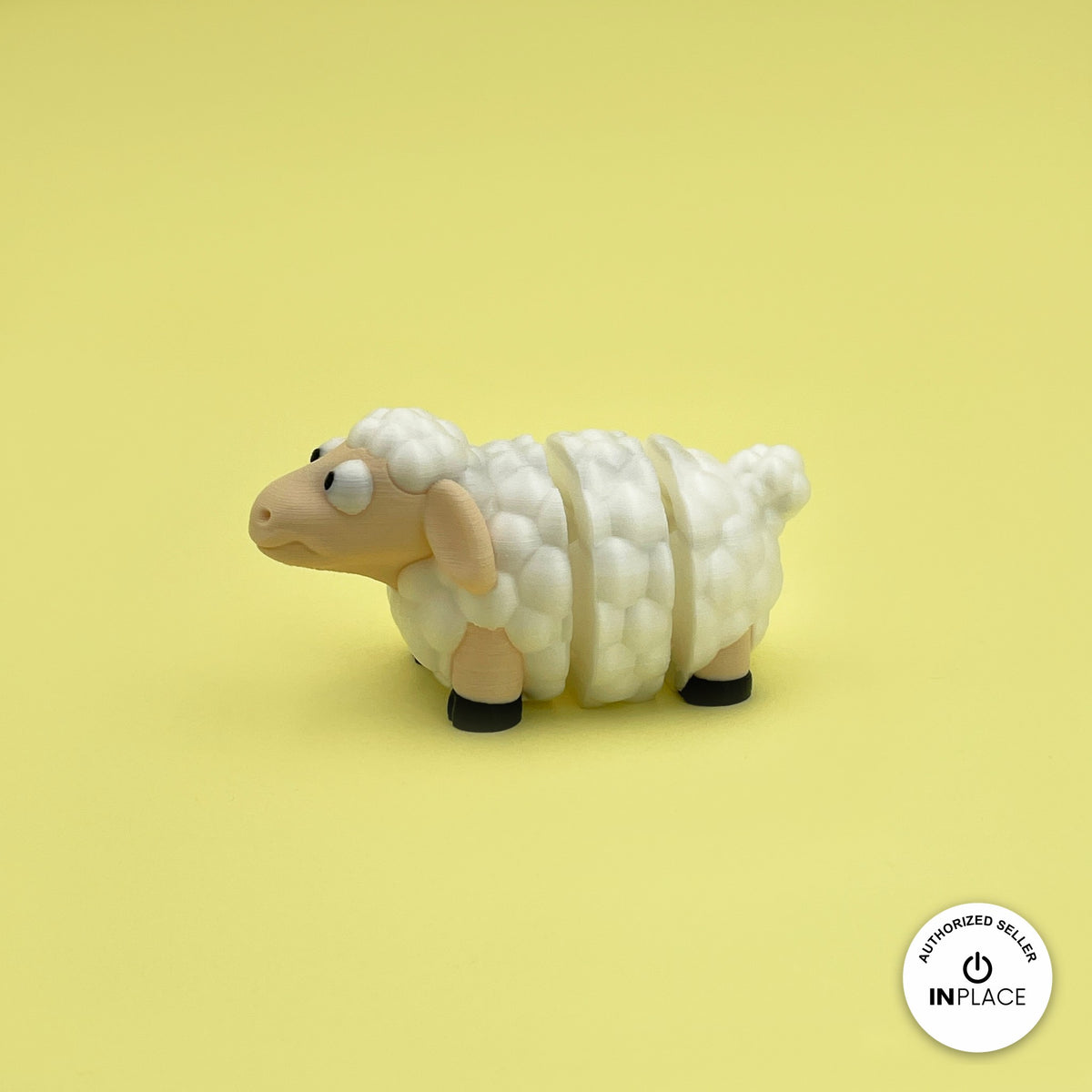 Cute sheep keychain, 3D printed by RU3D – side view facing left. Cream fluffy wool with black hooves.