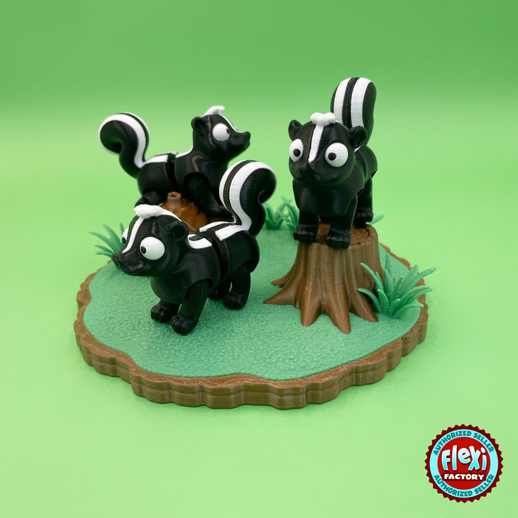 Cute skunk keychain, 3D printed by RU3D – group of skunks on woodland playset. Black and white with woodland log playset.