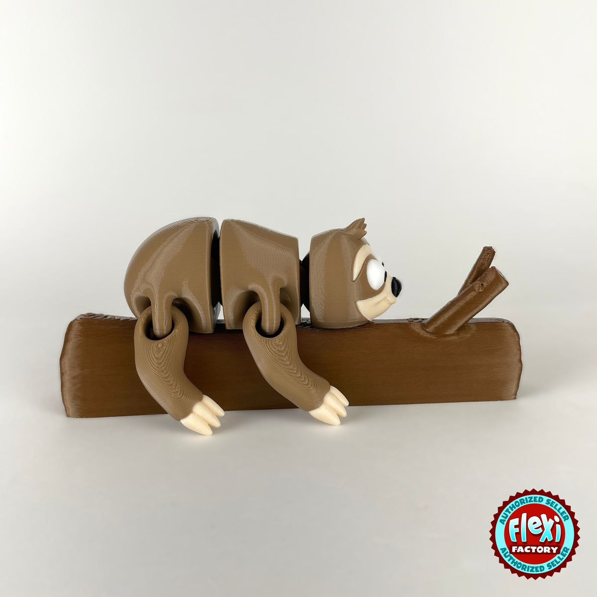 Cute sloth keychain, 3D printed by RU3D – hanging on branch side view. Brown with cream face hugging a branch.