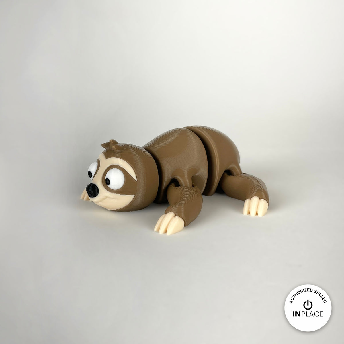 Cute sloth keychain, 3D printed by RU3D – lying down three quarter view. Brown with cream face hugging a branch.